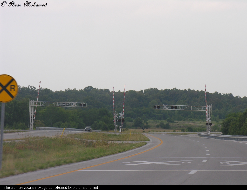 rj corman rr crossing along the local highway.