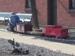 A miniature train moves through the Steamtown shops