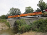 The two BNSF ES44C4's lead the trio of test units on GE's test track over a bridge