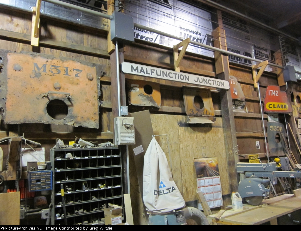 Various signs and old trolley front ends on shop wall