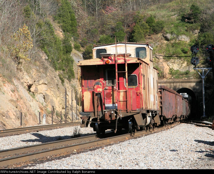 A work train sporting a caboose shoves past heading back to its home base