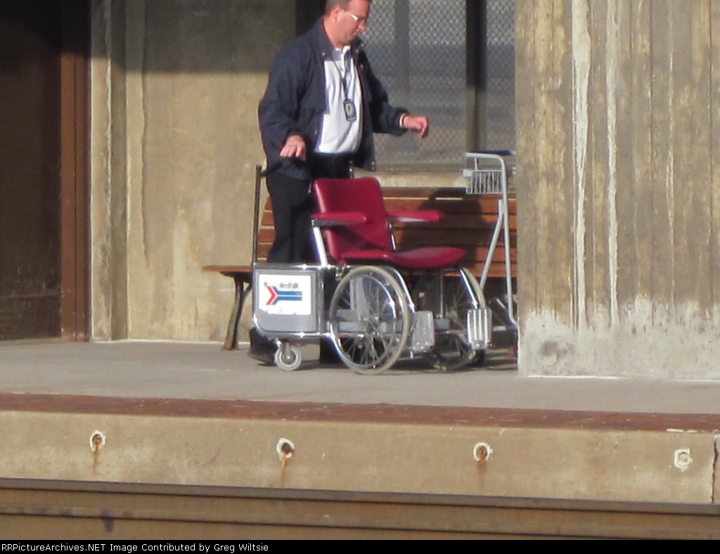 A station worker moves an Amtrak wheelchair after the Pennsylvanian departs
