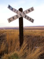 A vintage style crossbuck guards a quiet crossing.