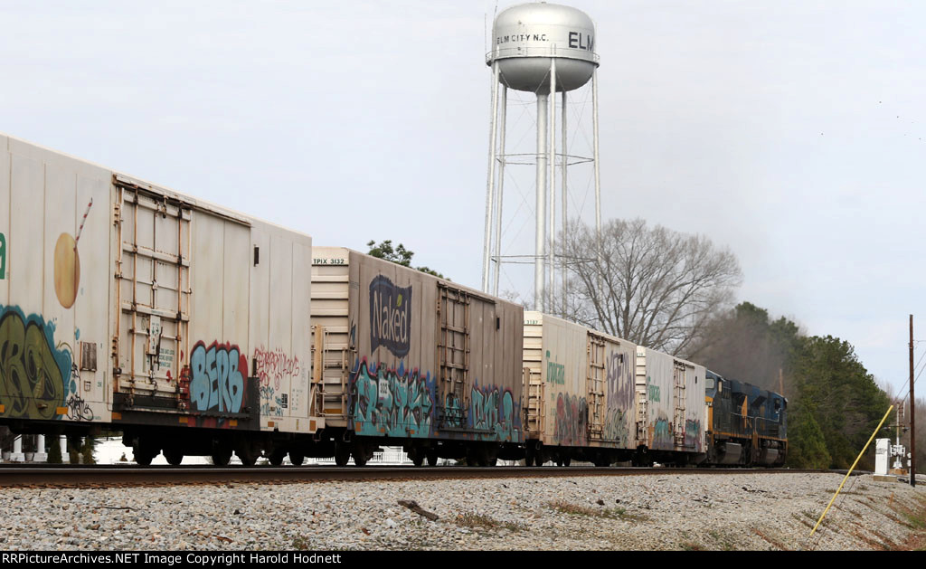 Train Q740-01 heads north, passing the water tower