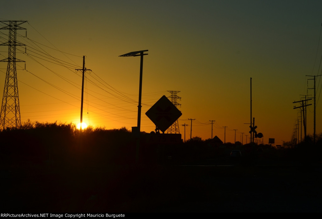 Sunset behind the rail crossing