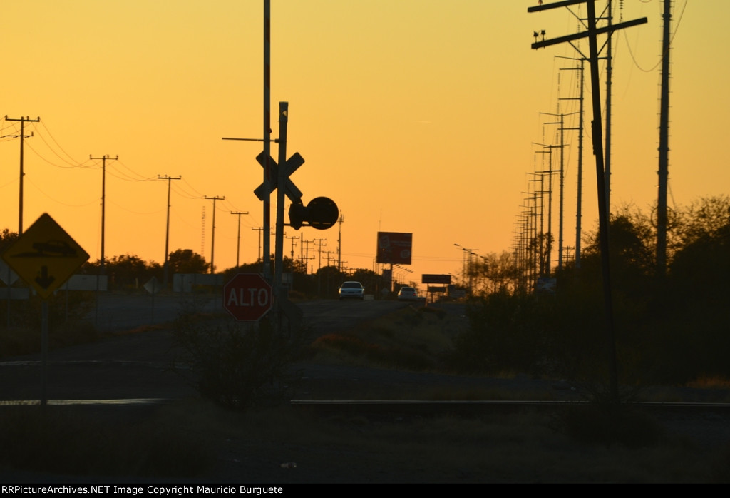 Sunset behind the rail crossing
