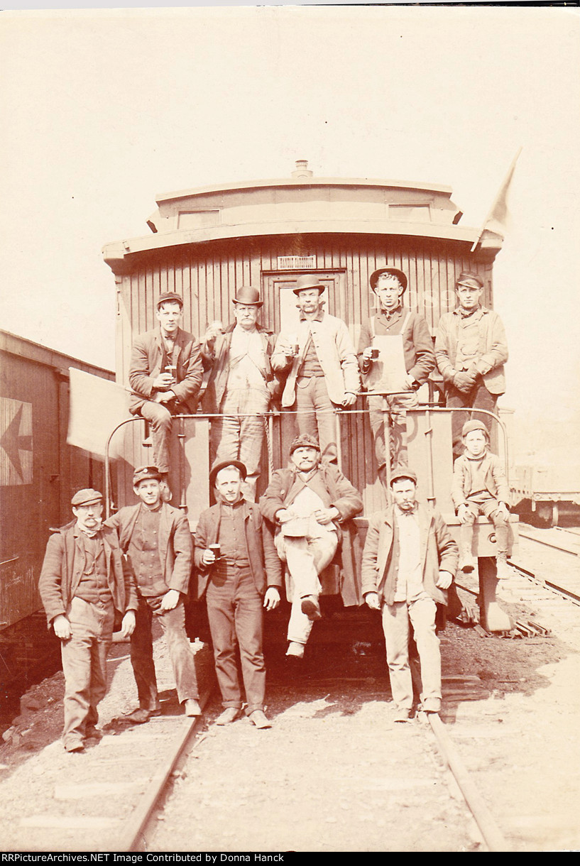 Ten men & one boy on a caboose