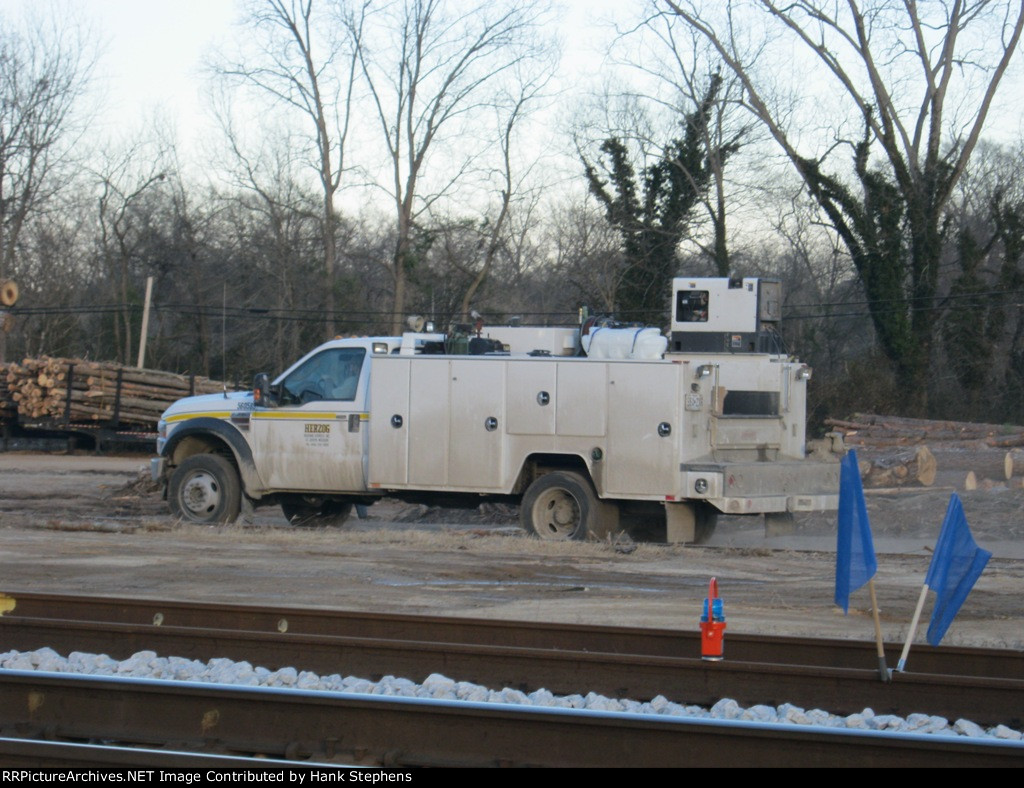 Shots of Herzog Contracting Mechanic truck working with ballast train at West Point, GA