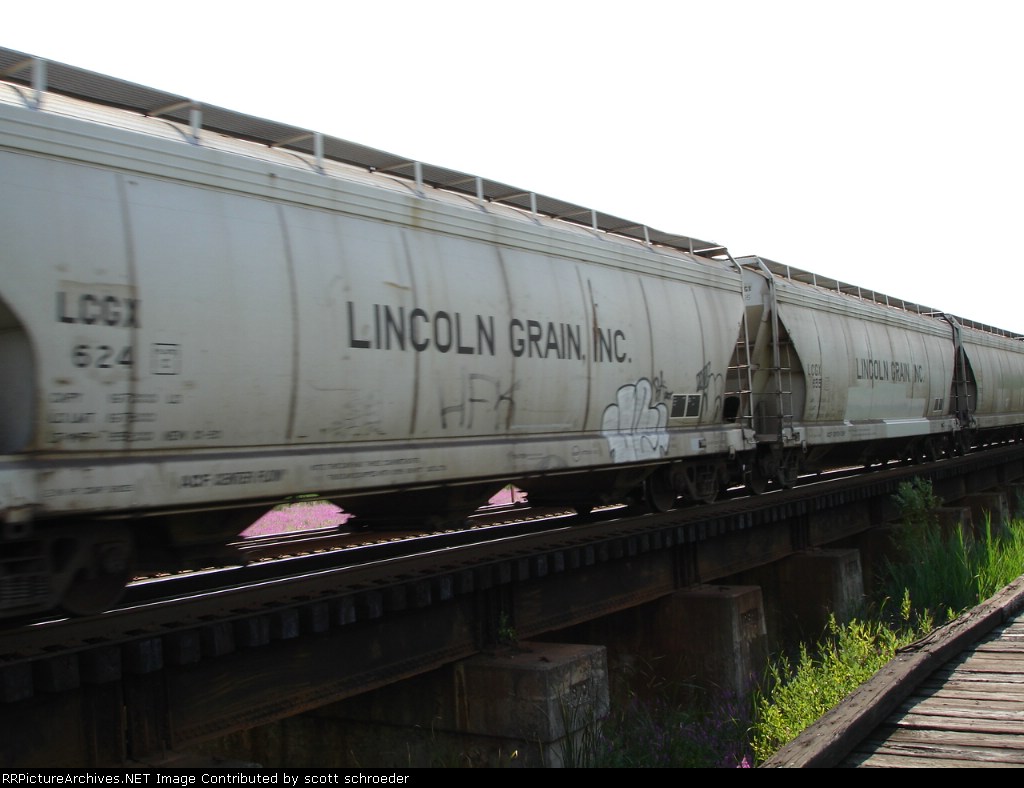 LINCOLN GRAIN, INC. Covered Grain Hoppers head EB on the #1 Track