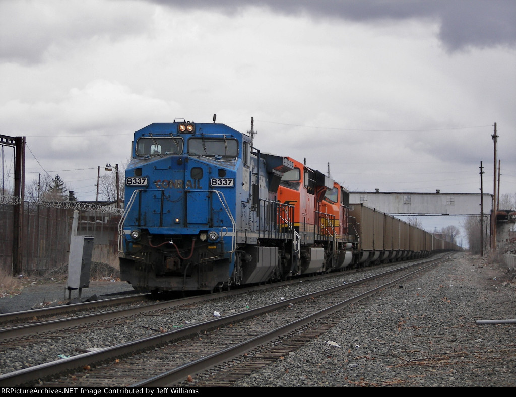 Stopped Train Near Airline Yard.