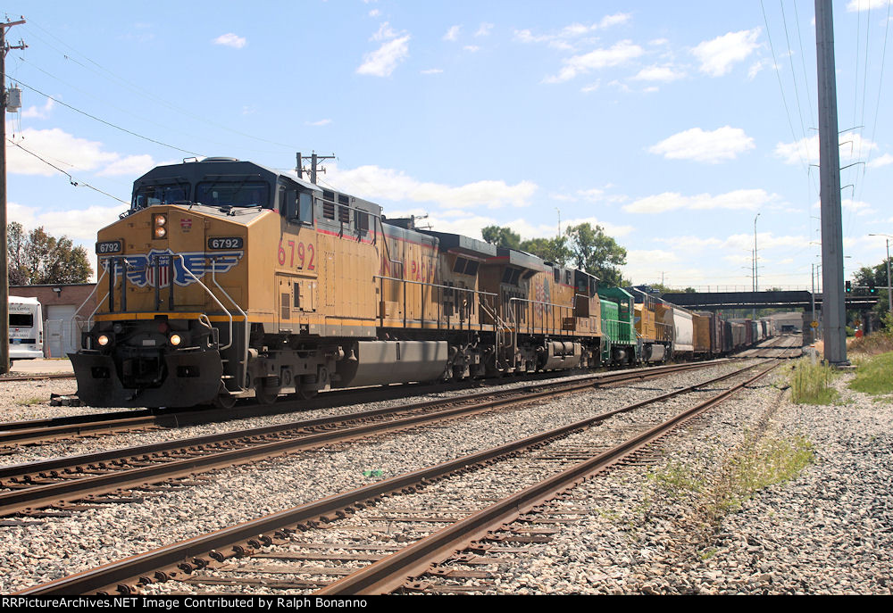 A northbound UP train on the IHB has an interesting switcher in its midst