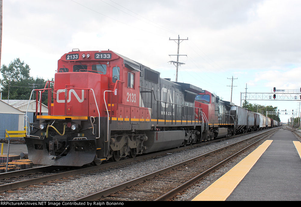A CN train waits to cross the CP/Metra line and enter the IHB with a C40-8 that was picked up from the UP and was orig. C&NW