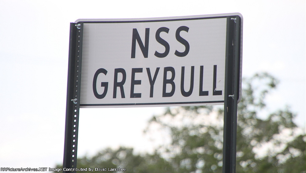 At the west end of the yard