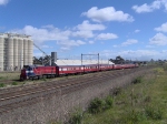 P 12 P25 push pulling a passenger train past the grain silo's
