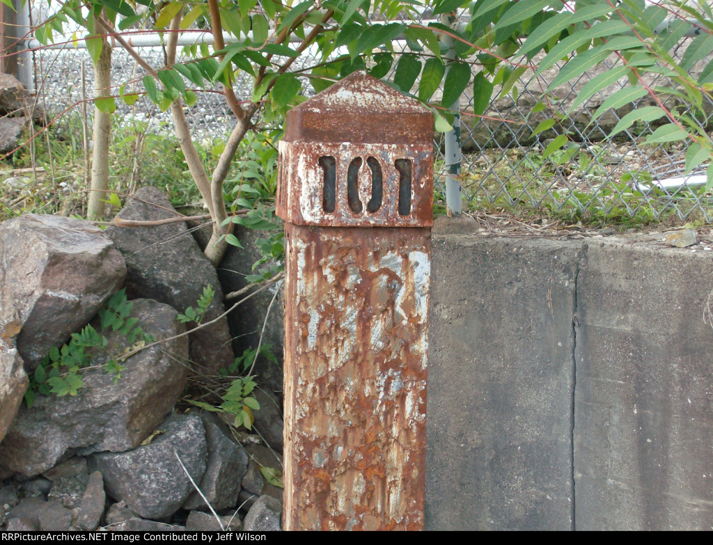 Die-cut metal mile post