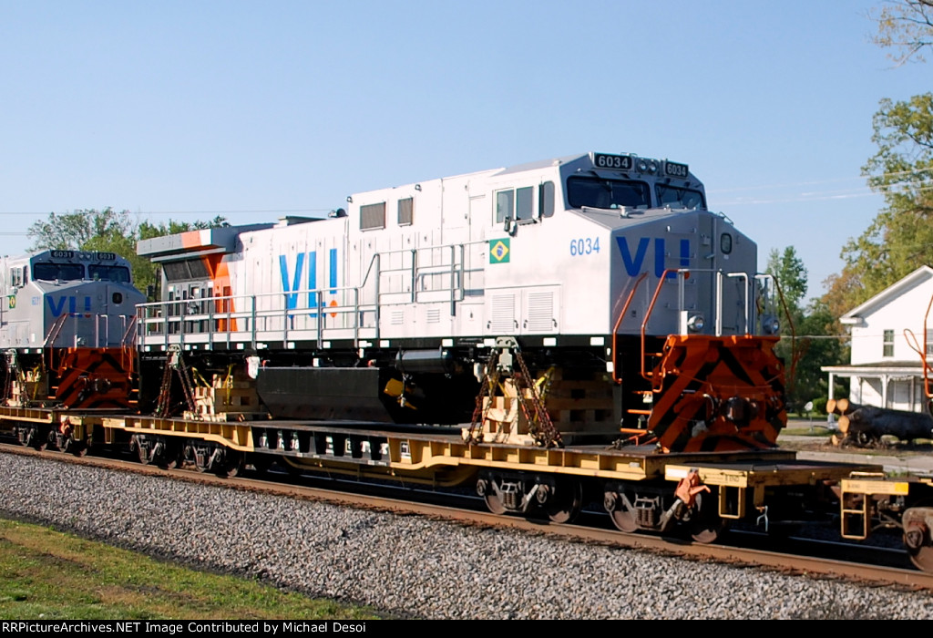 VLI BB40-9WM #6034 is one of 8 locomotives in this train heading east bound for the port of Norfolk VA, and then on to Brazil, seen here about to cross Maifeld Ave.