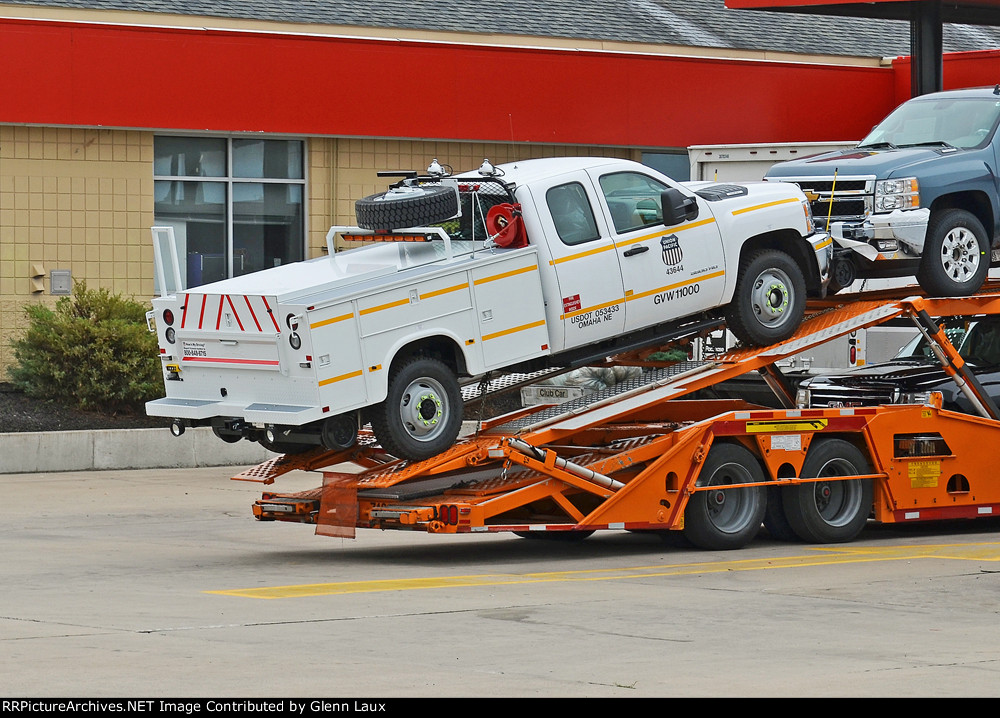 Brand new UP 43644 Hy-railer being shipped on a car hauler.