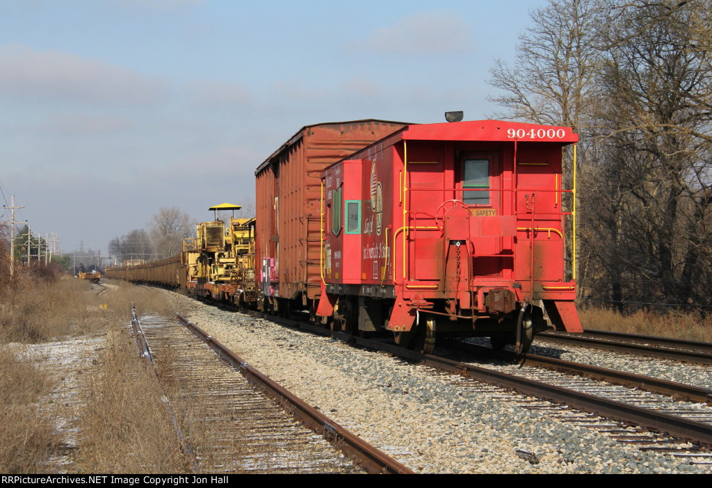 An empty rail train and stored well cars sit in the sidings near the north end of Grand Blanc