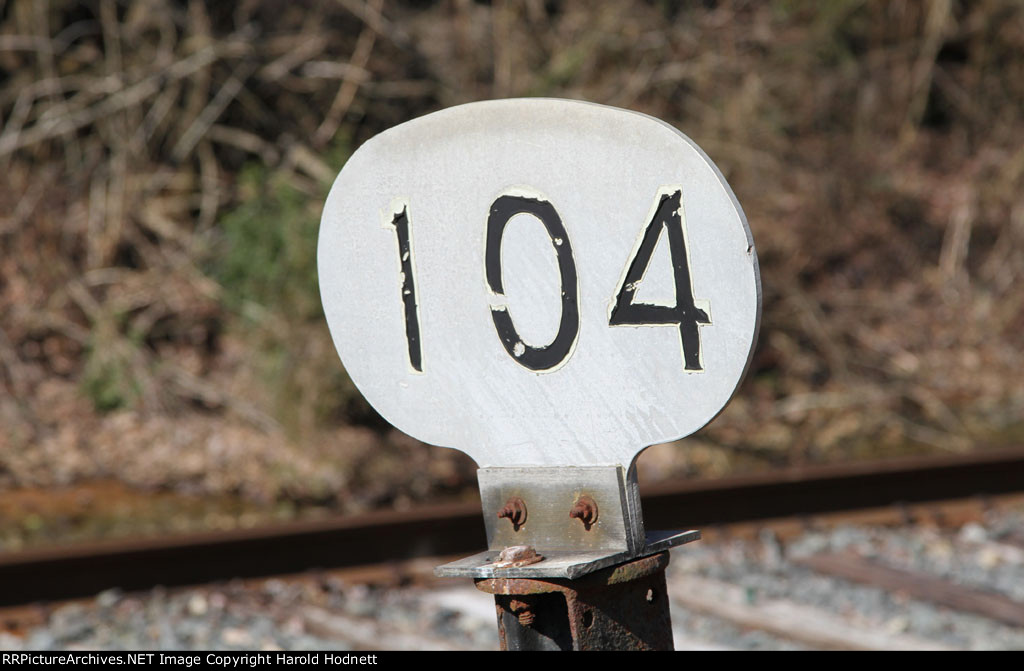 MP 104 stands almost next to the large city limits sign on the north side of town