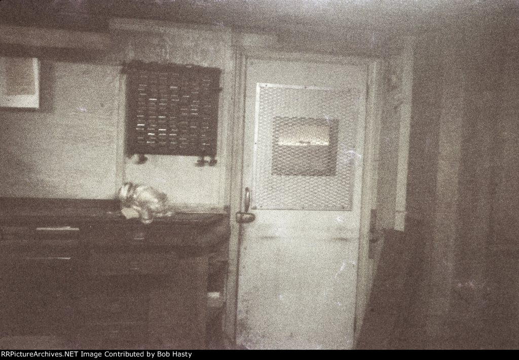 Looking through a ticket window, you an see what remained of the ticket office. 