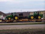 One of eight flatcars loaded w/John Deere tractors