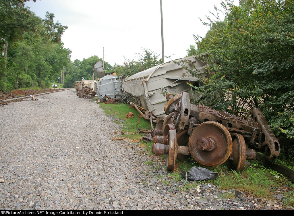 Four covered hoppers on the ground...