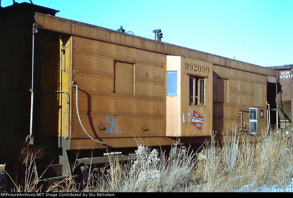 Milwaukee Road Caboose sidelined and white-lined.