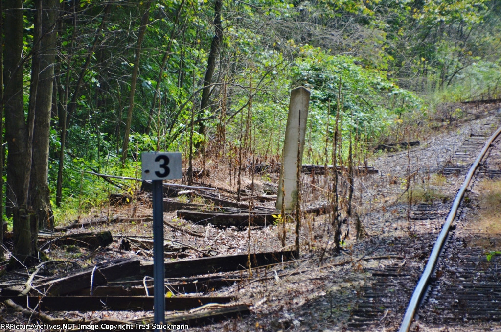 A whistle post for Merrian Rd. and milepost 3.