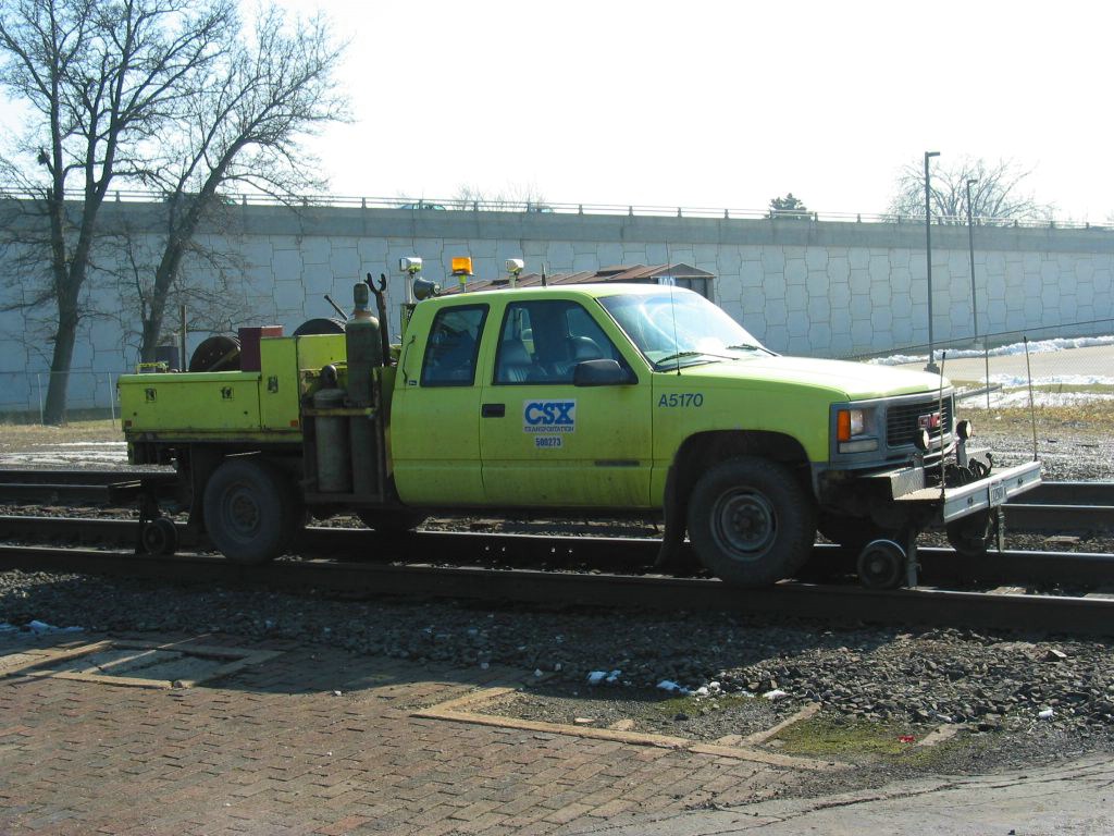 csx hy-rail truck parked on rails