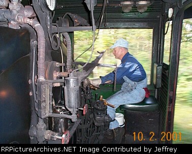 Here is a picture of the engineer on my cab ride. Notice the scenery going by in the background
