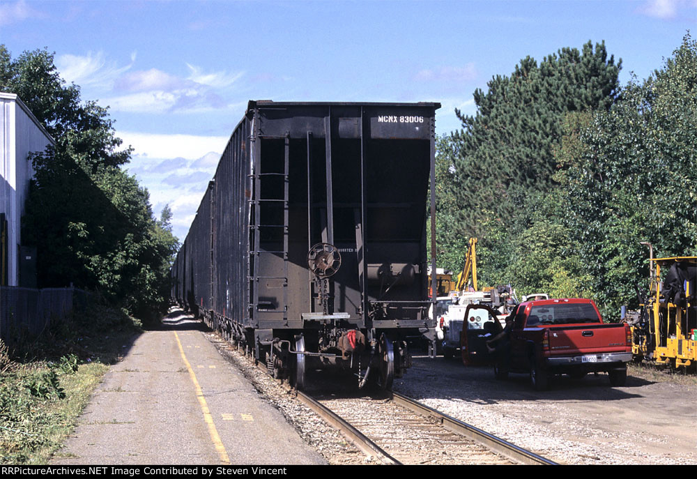NCER local with Burlington Electric hoppers including MCNX #83006.