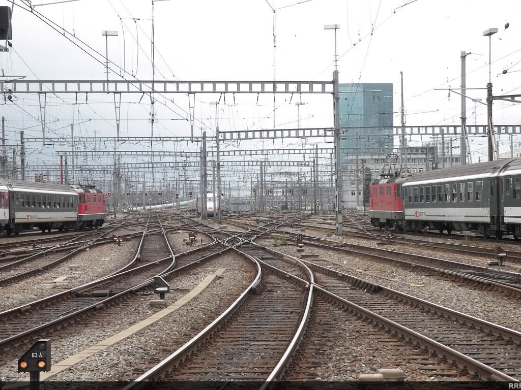 Two SBB trains heading out with an ICE train coming in.  
