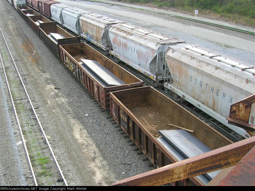 C 687883 loaded with big pieces of steel leaving hump yard