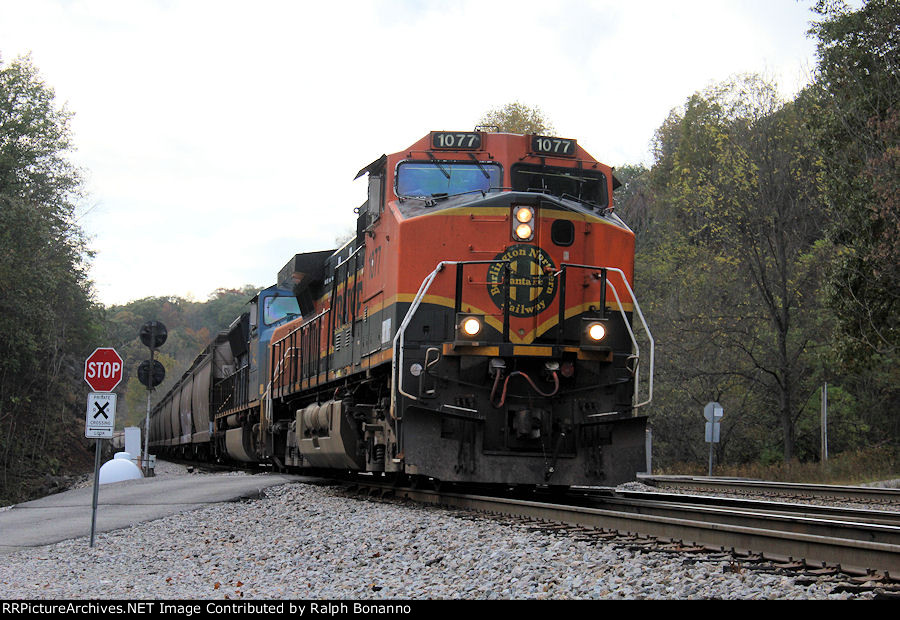 An eastbound grain train with BNSF/CSX power descends the grade at Laurel interlocking