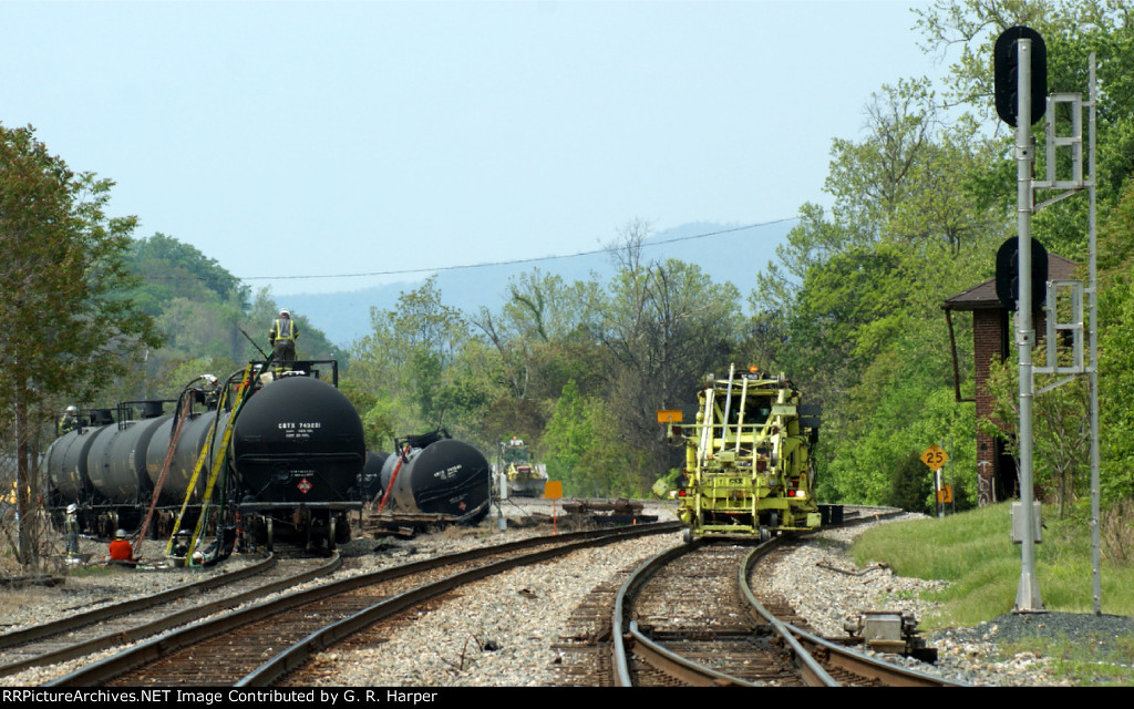 M of W machinery moving east to get out of the way of the rail train coming to set of rail