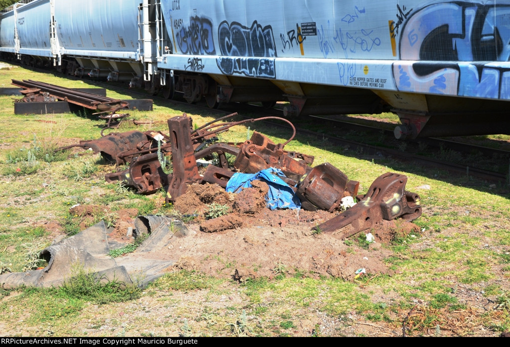Old couplers and scrap laying on the yard