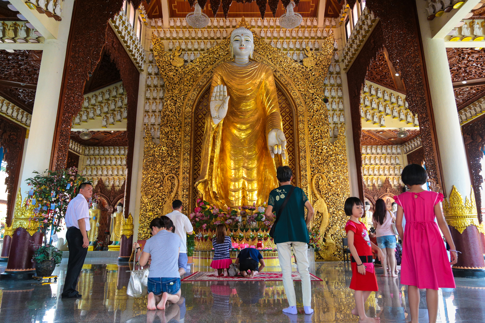 praying inside the Dhammikarama_179746655