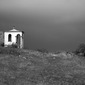 Dark clouds over a chapel