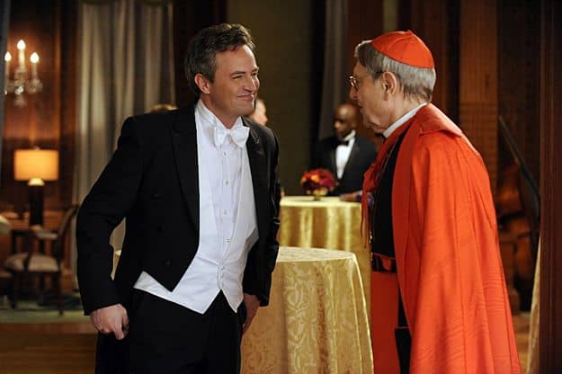 THE GOOD WIFE Season 4 Episode 18 Death Of A Client Mike Kresteva (Matthew Perry, left), Peter's political rival, tries to curry favor with Cardinal James (John Cullum, right)