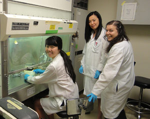 Emily Pang (left) with lab technicians at Stony Brook University