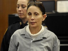 Gigi Jordan is led into a Manhattan court for a hearing.