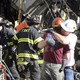 Construction workers embrace after an Upper East Side crane collapse.(AP Photo/Mary Altaffer)