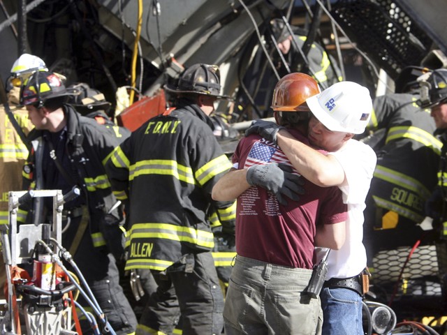 Construction workers embrace after an Upper East Side crane collapse.