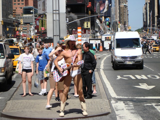 The Naked Cowboy performs in Times Square.