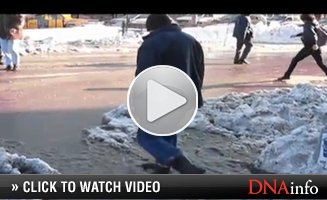 Pedestrians created a traffic jam trying to find a way around the puddle.