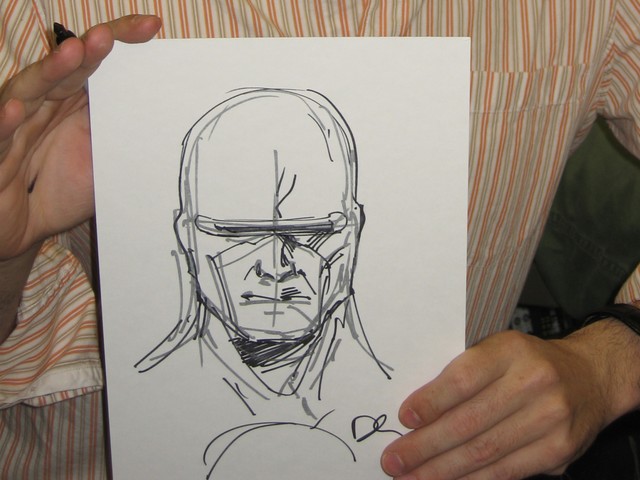 Comic Artist Dennis Calero shows off a free sketch of Dr. Solar he did for a lucky fan.