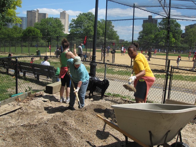 Homer's Run volunteers shovel gravel to spread along the run.