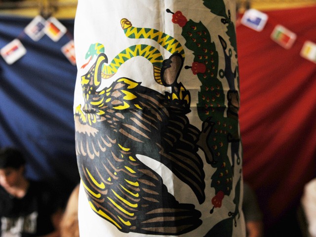 A Mexican flag foreground and French flag background.