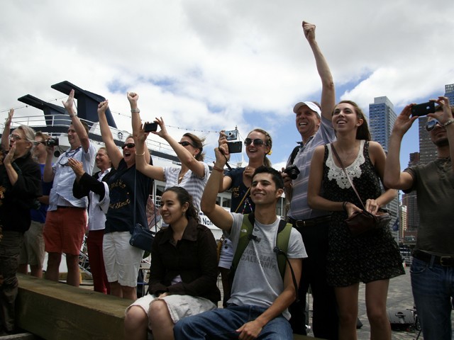 Friends and family cheer Reid on as he approaches the dock at Pier 81 in Manhattan.