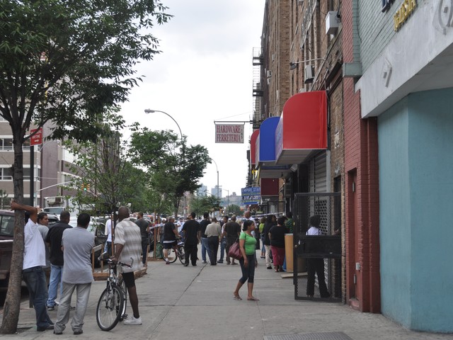 Crowds of neighbors and building residents stood outside waiting to learn what happened inside.